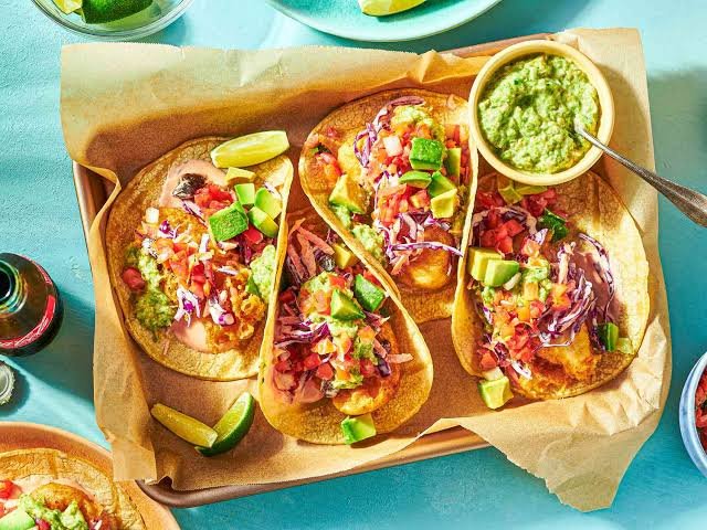 Baja-style grilled fish tacos with cabbage slaw and cilantro sauce