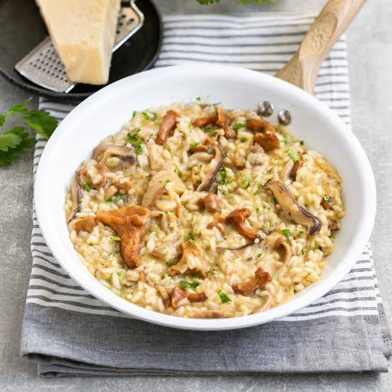 Creamy wild mushroom risotto garnished with parsley and parmesan